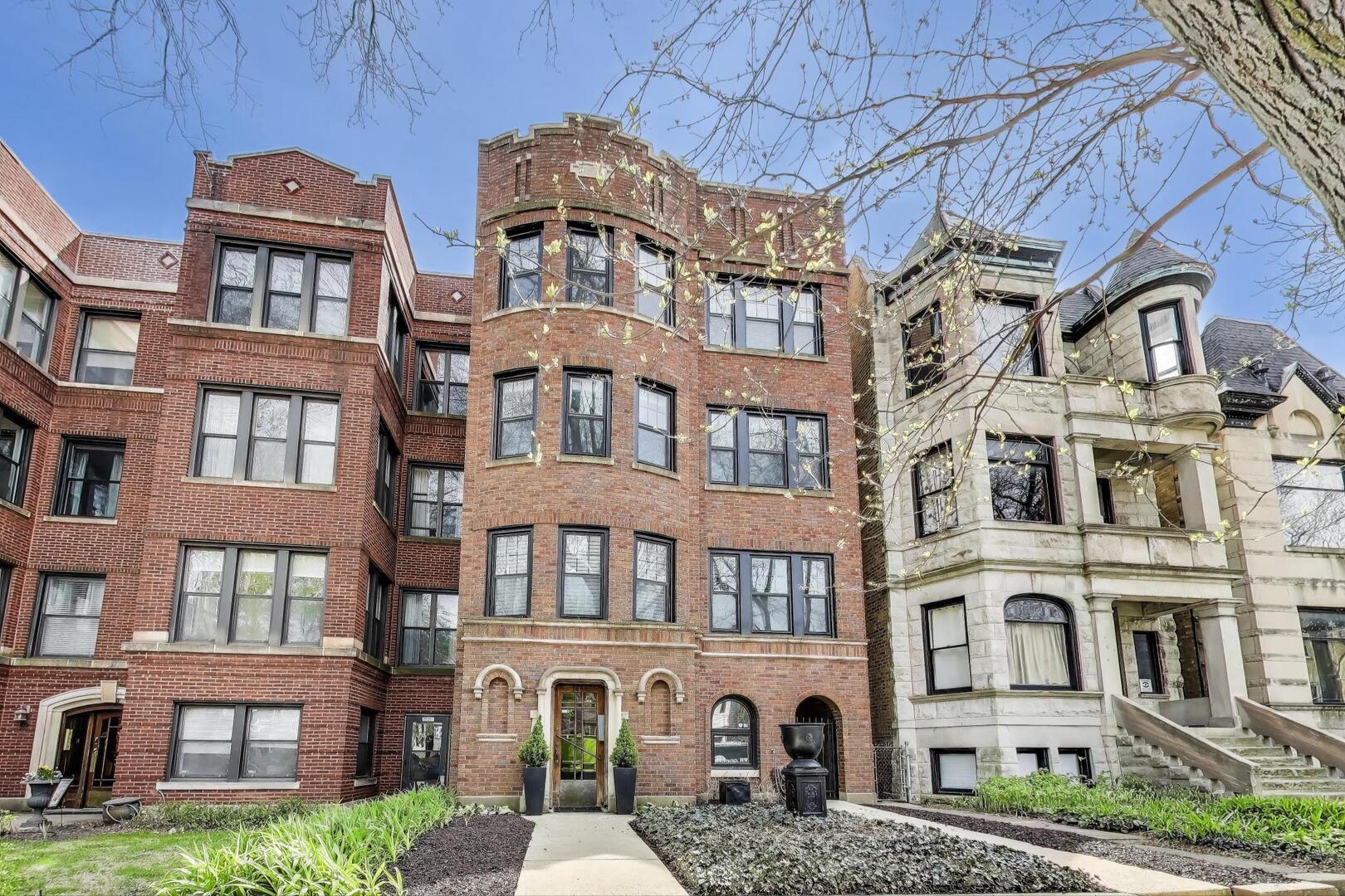 a front view of a building with a yard