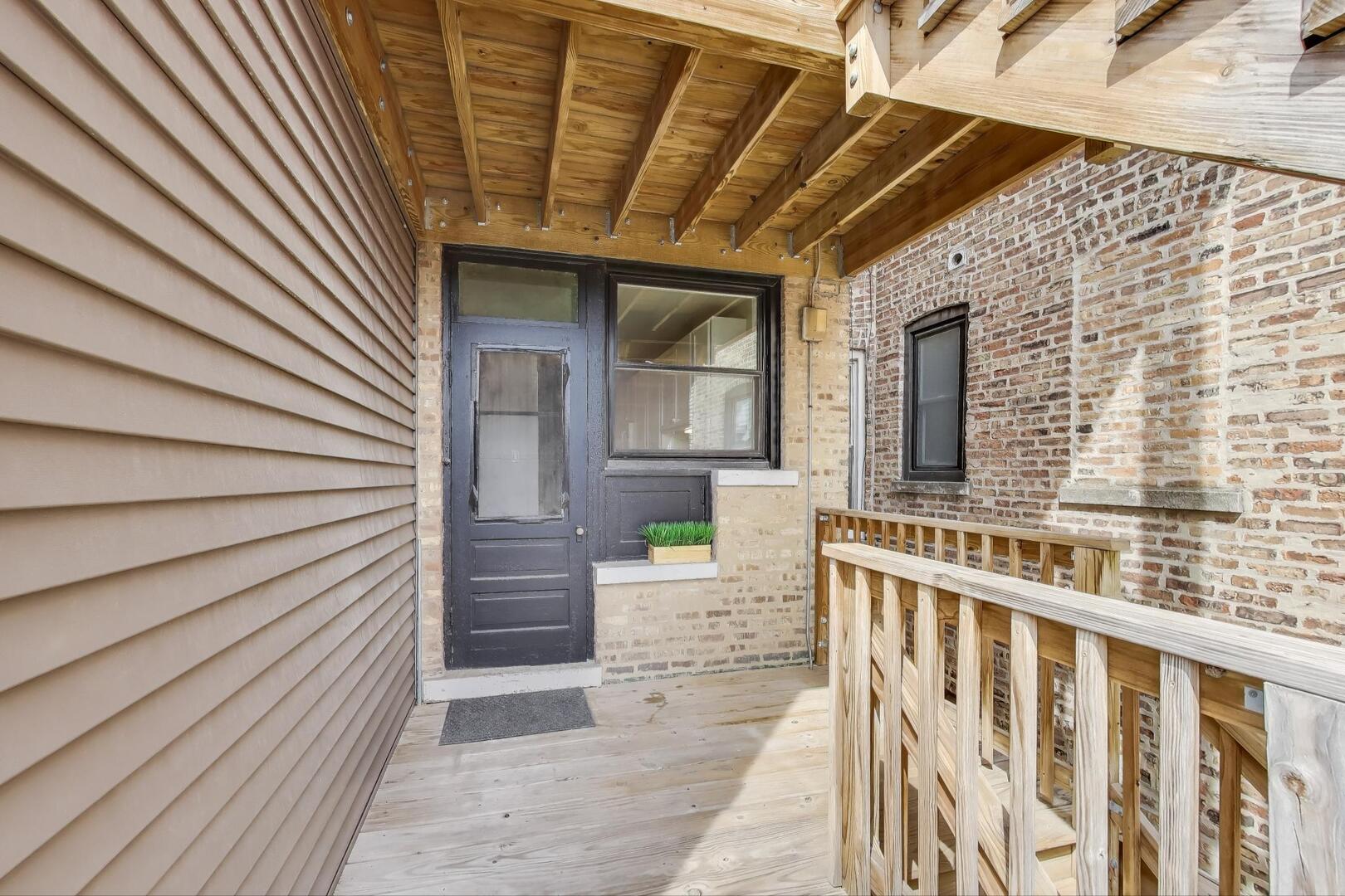 1451 West Warner Avenue, Unit 2 Chicago, IL 60613 - Photo 22 of 23 a porch with seating space