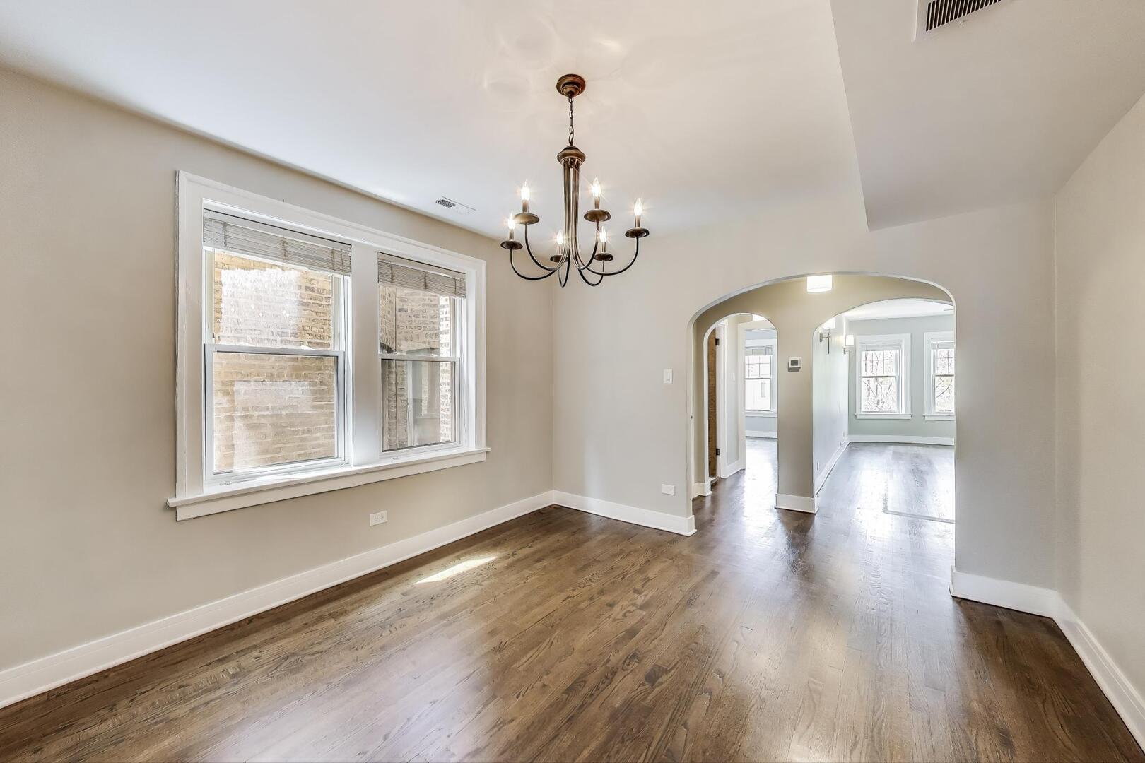 1451 West Warner Avenue, Unit 2 Chicago, IL 60613 - Photo 6 of 23 a view of a room with wooden flooring and stainless steel appliances