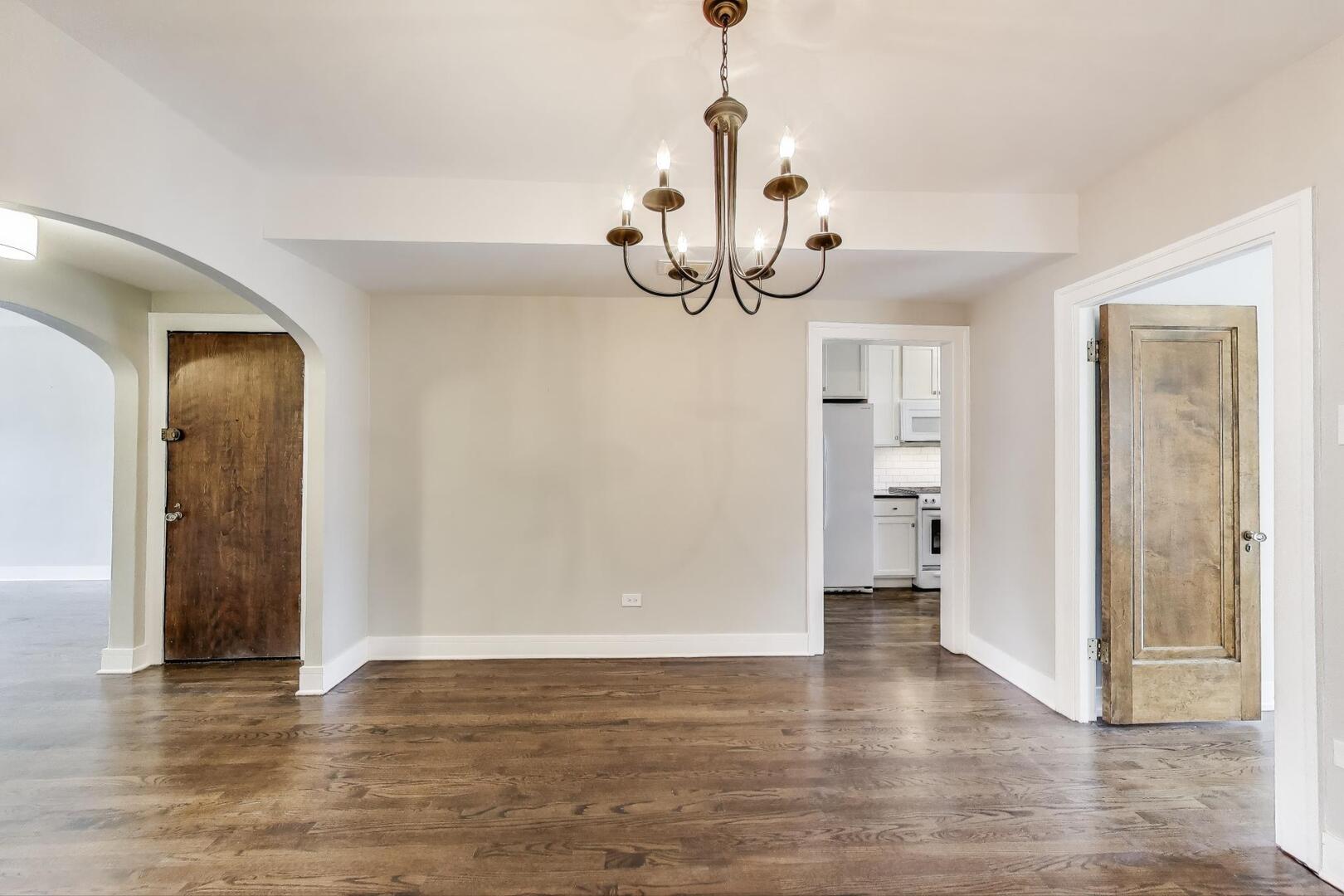 1451 West Warner Avenue, Unit 2 Chicago, IL 60613 - Photo 7 of 23 a view of a livingroom with wooden floor and staircase