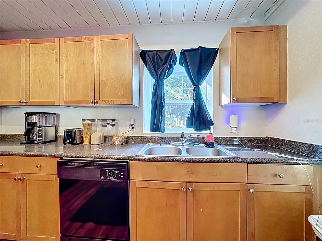 772 East Michigan Street, Unit 70 Orlando, FL 32806 - Photo 13 of 54 a kitchen with stainless steel appliances granite countertop a sink stove and cabinets