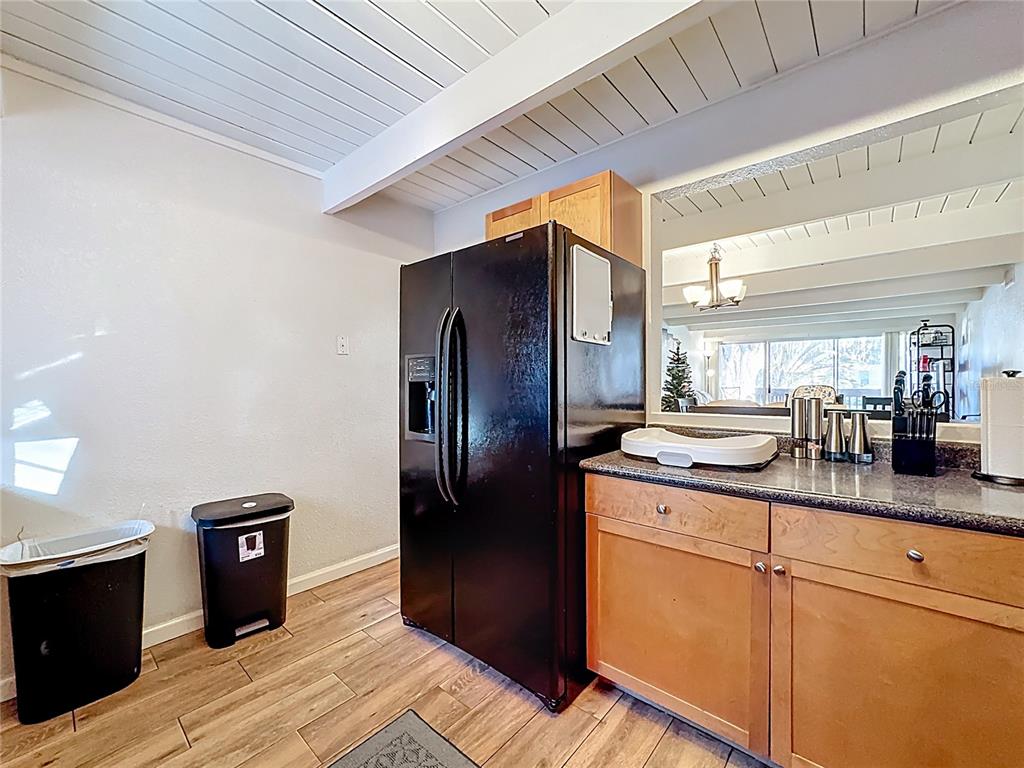 772 East Michigan Street, Unit 70 Orlando, FL 32806 - Photo 14 of 54 a kitchen with stainless steel appliances granite countertop a refrigerator a stove and a wooden floors