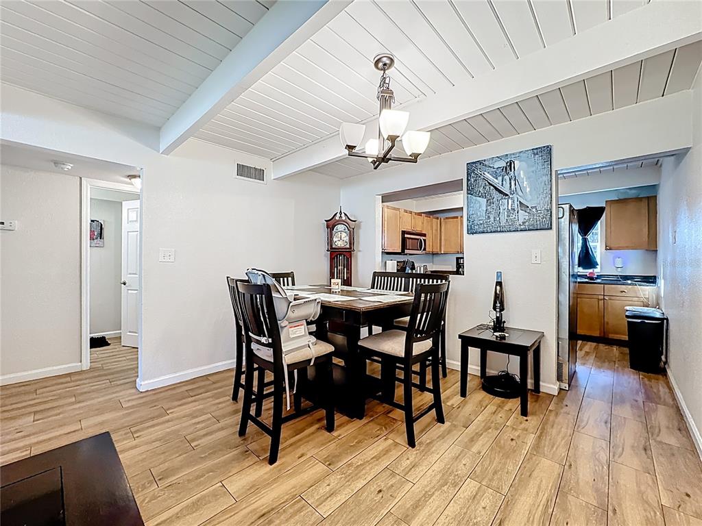 772 East Michigan Street, Unit 70 Orlando, FL 32806 - Photo 19 of 54 a view of a dining room with furniture and wooden floor