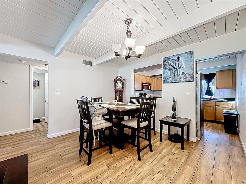 772 East Michigan Street, Unit 70 Orlando, FL 32806 - Photo 20 of 54 a view of a dining room with furniture and wooden floor