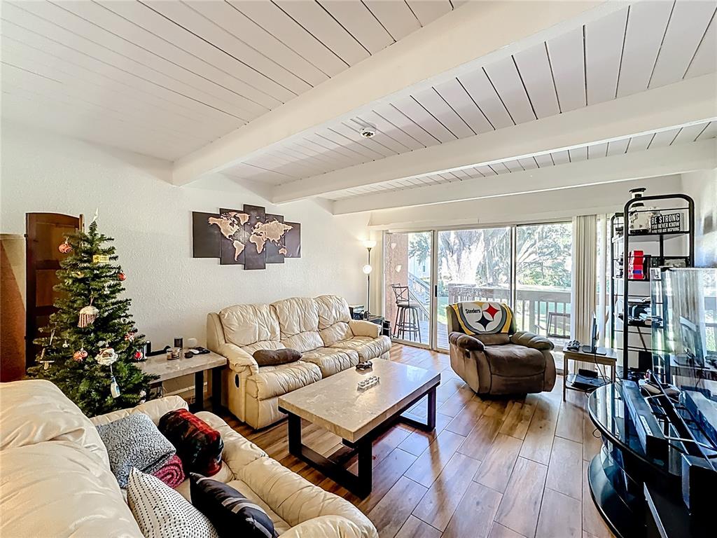 772 East Michigan Street, Unit 70 Orlando, FL 32806 - Photo 23 of 54 a living room with furniture large window and a flat screen tv