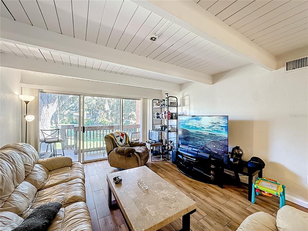 772 East Michigan Street, Unit 70 Orlando, FL 32806 - Photo 24 of 54 a living room with furniture a couch and a flat screen tv