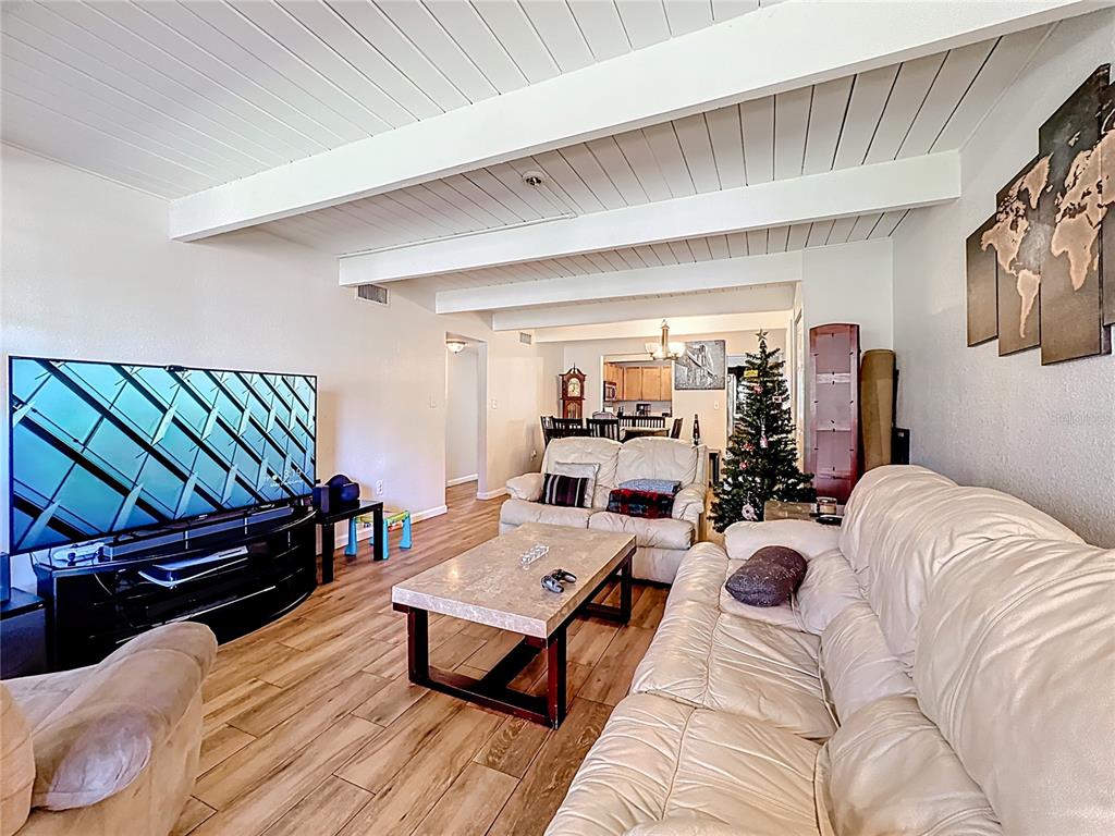 772 East Michigan Street, Unit 70 Orlando, FL 32806 - Photo 25 of 54 a living room with furniture and a wooden floor
