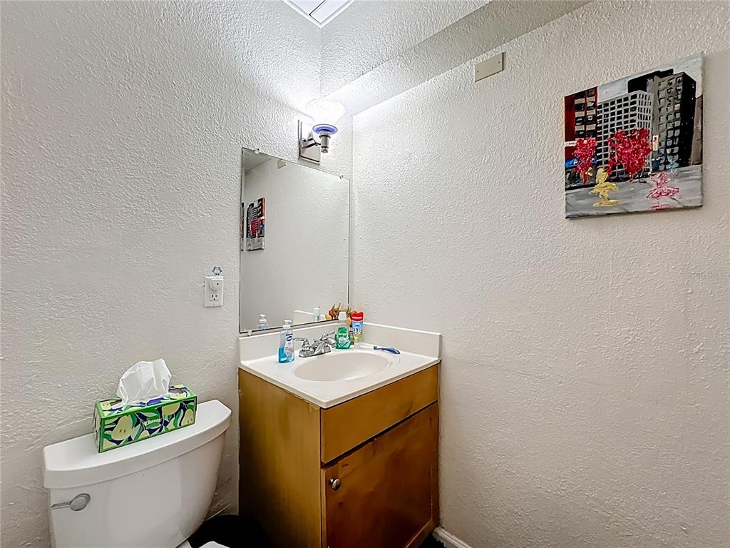 772 East Michigan Street, Unit 70 Orlando, FL 32806 - Photo 26 of 54 a bathroom with a sink mirror and vanity