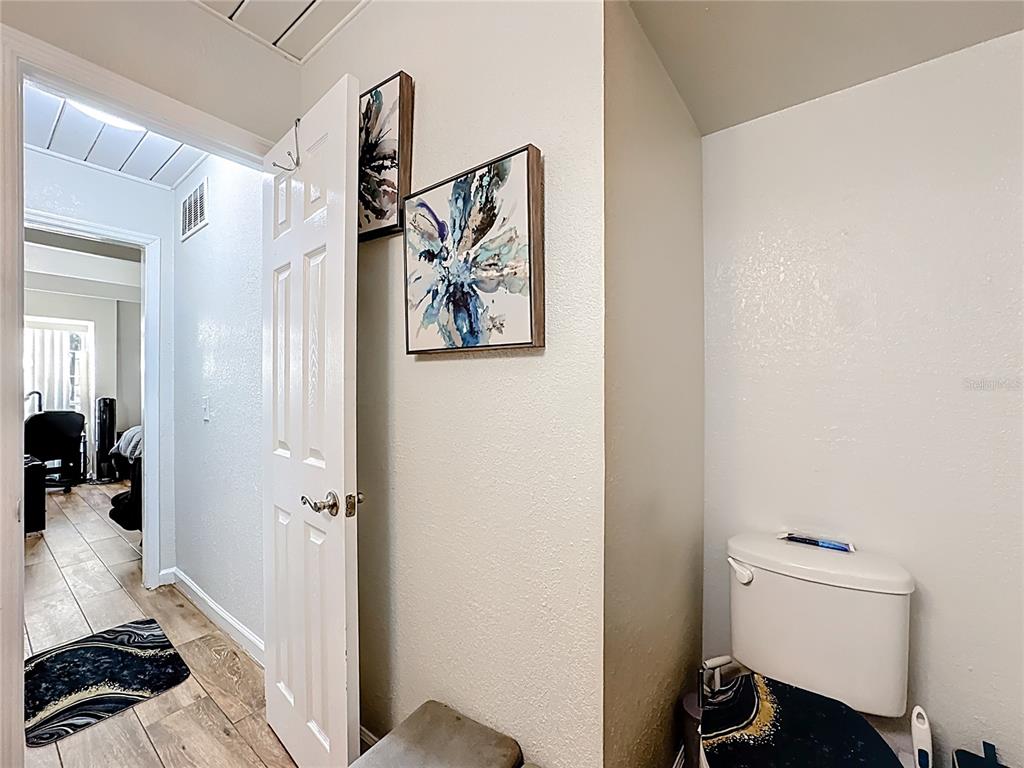 772 East Michigan Street, Unit 70 Orlando, FL 32806 - Photo 33 of 54 a bedroom with a bed and wooden floor