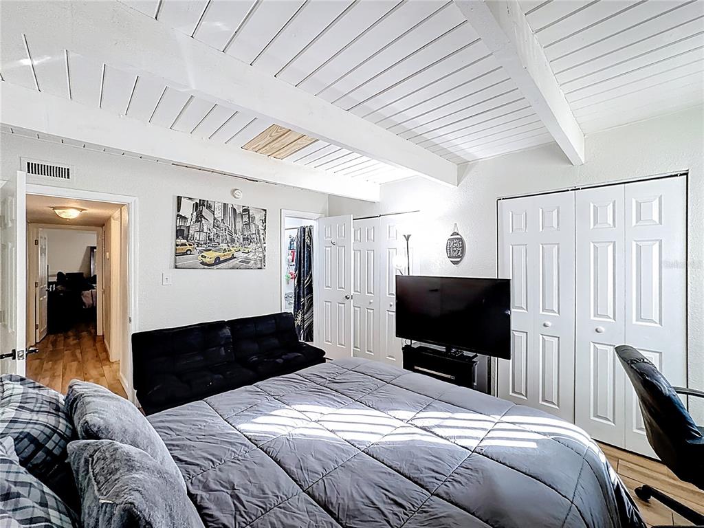 772 East Michigan Street, Unit 70 Orlando, FL 32806 - Photo 37 of 54 a bedroom with a bed and a flat screen tv