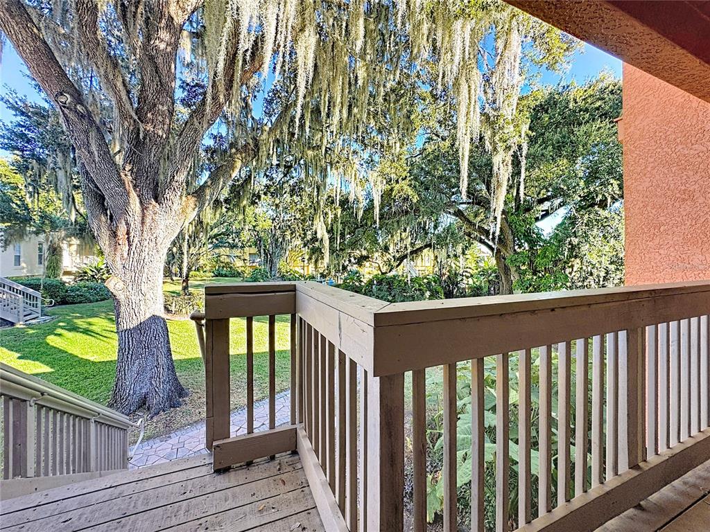 772 East Michigan Street, Unit 70 Orlando, FL 32806 - Photo 38 of 54 a view of a balcony with wooden floor and fence