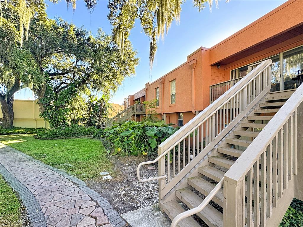 772 East Michigan Street, Unit 70 Orlando, FL 32806 - Photo 40 of 54 a view of an house with backyard and trees