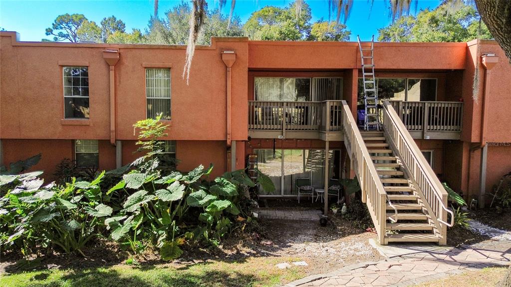 772 East Michigan Street, Unit 70 Orlando, FL 32806 - Photo 42 of 54 a front view of a house with a yard