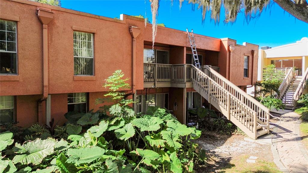 772 East Michigan Street, Unit 70 Orlando, FL 32806 - Photo 43 of 54 a view of a house with wooden fence and potted plants