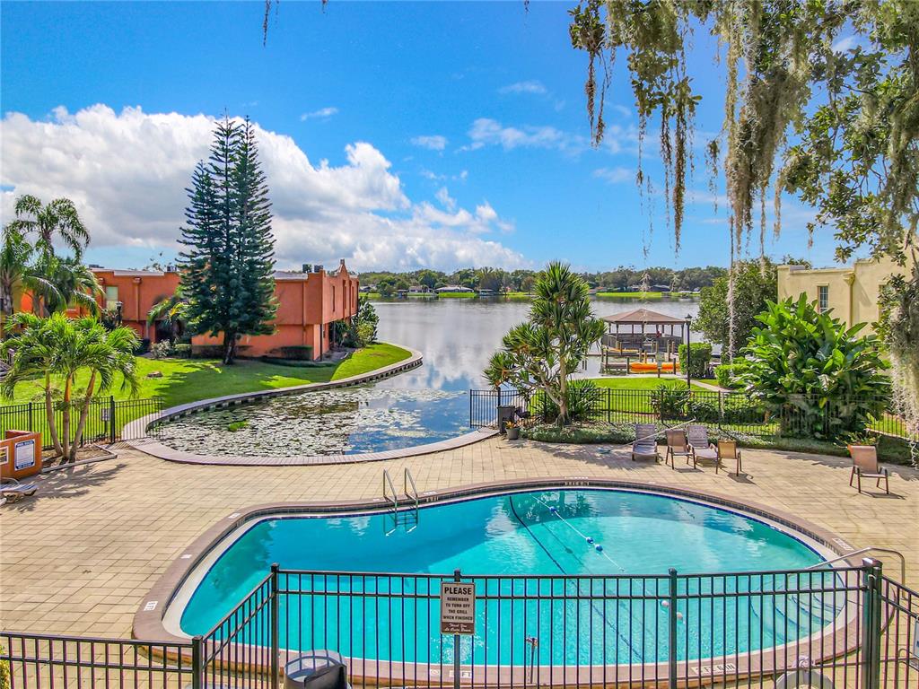 772 East Michigan Street, Unit 70 Orlando, FL 32806 - Photo 48 of 54 a view of a swimming pool with a patio and a garden
