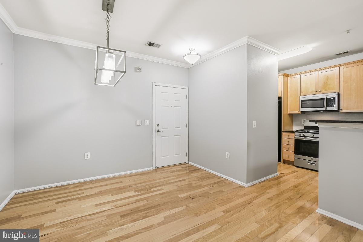 11800 Old Georgetown Road, Unit 1323 North Bethesda, MD 20852 - Photo 2 of 42 a view of a kitchen with a sink and dishwasher a refrigerator with wooden floor