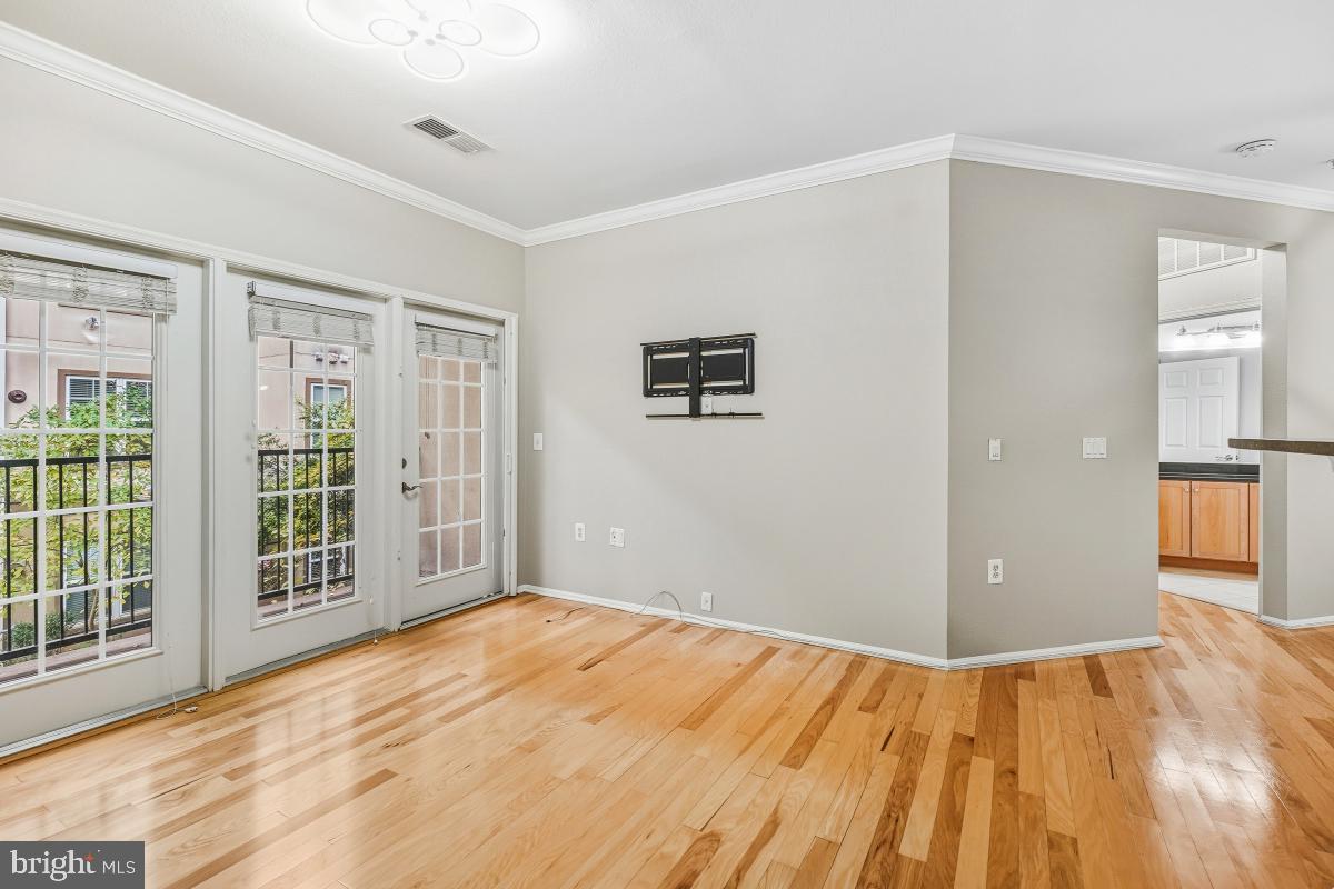 11800 Old Georgetown Road, Unit 1323 North Bethesda, MD 20852 - Photo 10 of 42 a view of an empty room with wooden floor and a window