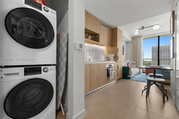 a view of a kitchen with washer and dryer