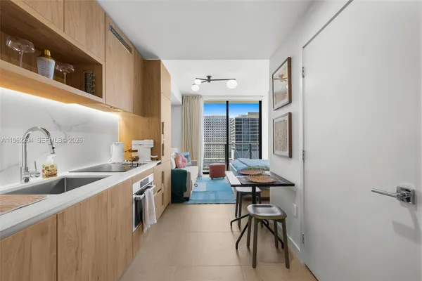 a view of a kitchen with a sink and cabinets