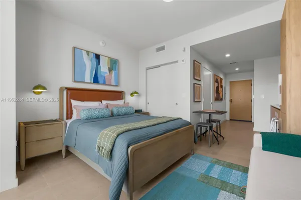 a bedroom with a bed and a table