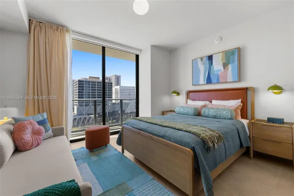 a spacious bedroom with a bed and a window