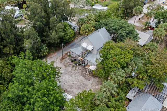 an aerial view of a house with a yard and outdoor seating