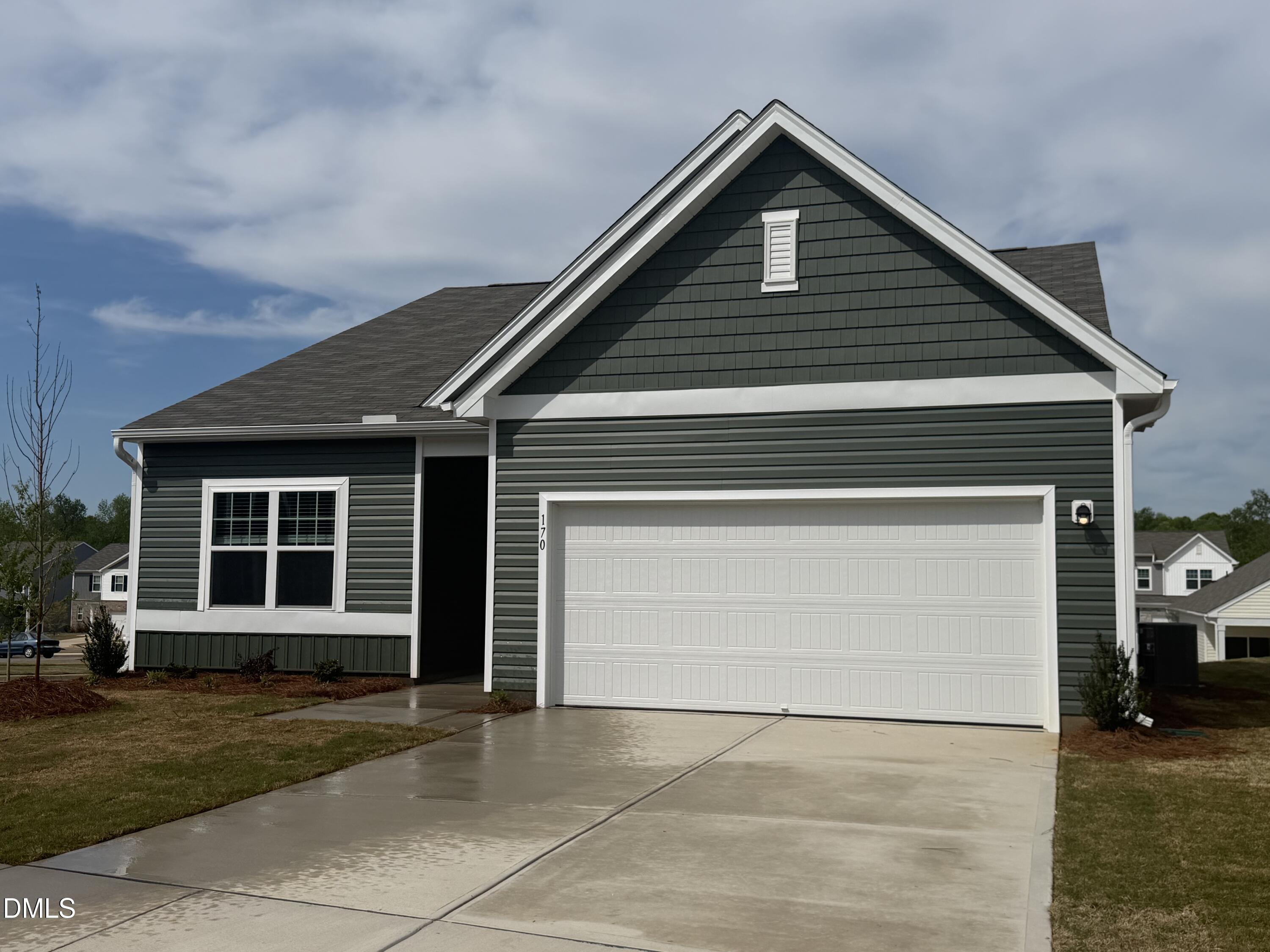 170 Bedstone Way Clayton, NC 27520 - Photo 3 of 22 a front view of a house with a yard and garage