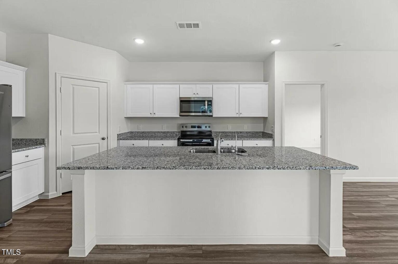 170 Bedstone Way Clayton, NC 27520 - Photo 5 of 22 a kitchen with granite countertop a sink and a stove