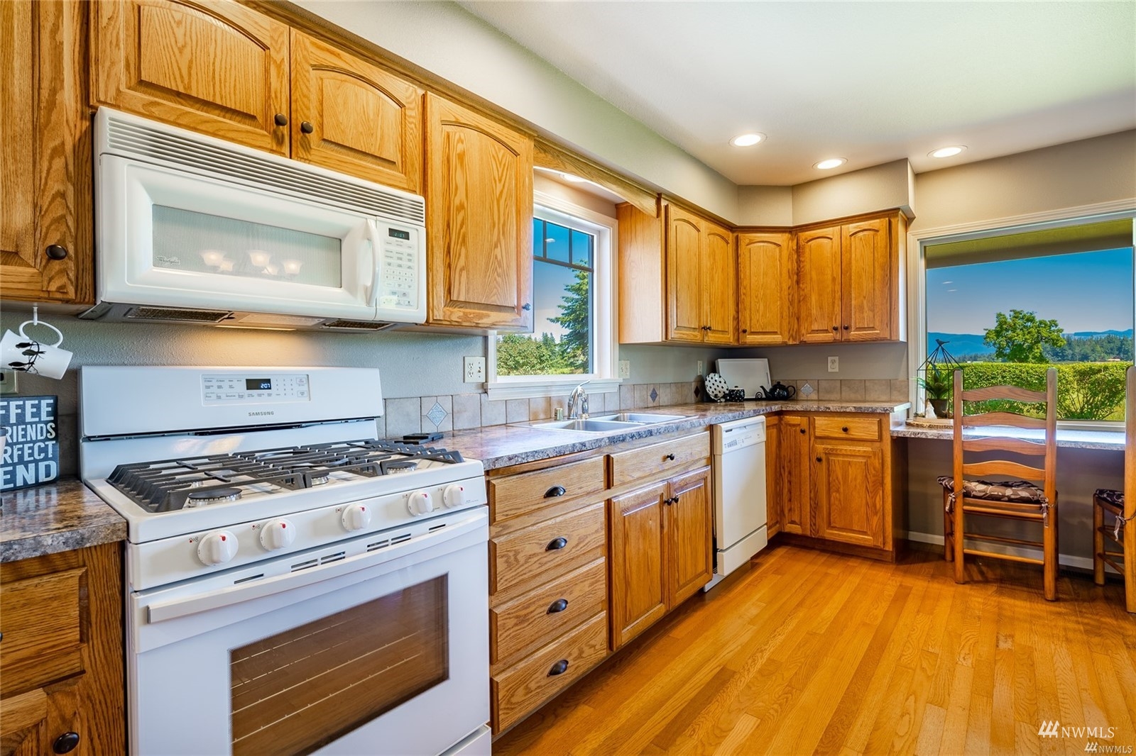 356 East Pole Road Lynden, WA 98264 - Photo 11 of 40 a kitchen with a stove a sink and a microwave