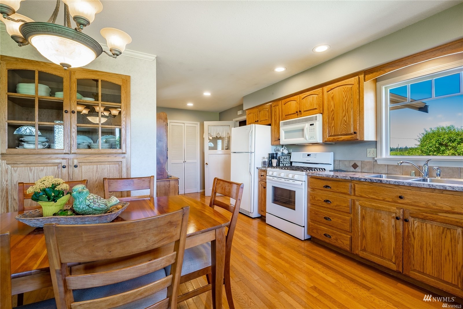 356 East Pole Road Lynden, WA 98264 - Photo 12 of 40 a kitchen with stainless steel appliances granite countertop wooden cabinets a stove a sink a dining table and chairs