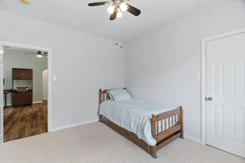 a bedroom with a bed and ceiling fan