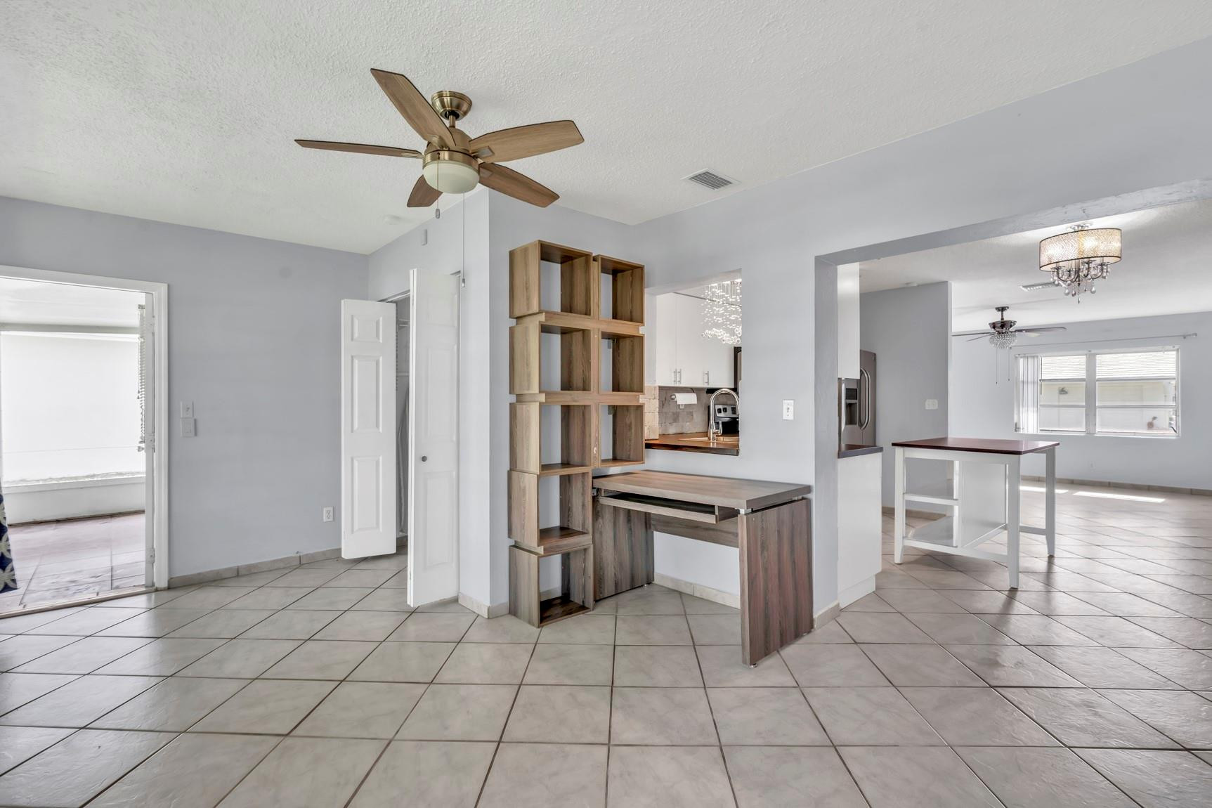 7115 Northwest 73rd Street Tamarac, FL 33321 - Photo 13 of 46 a open kitchen with cabinets and stainless steel appliances