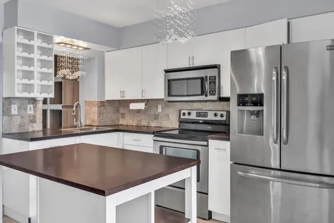 a kitchen with stainless steel appliances granite countertop a stove and cabinets