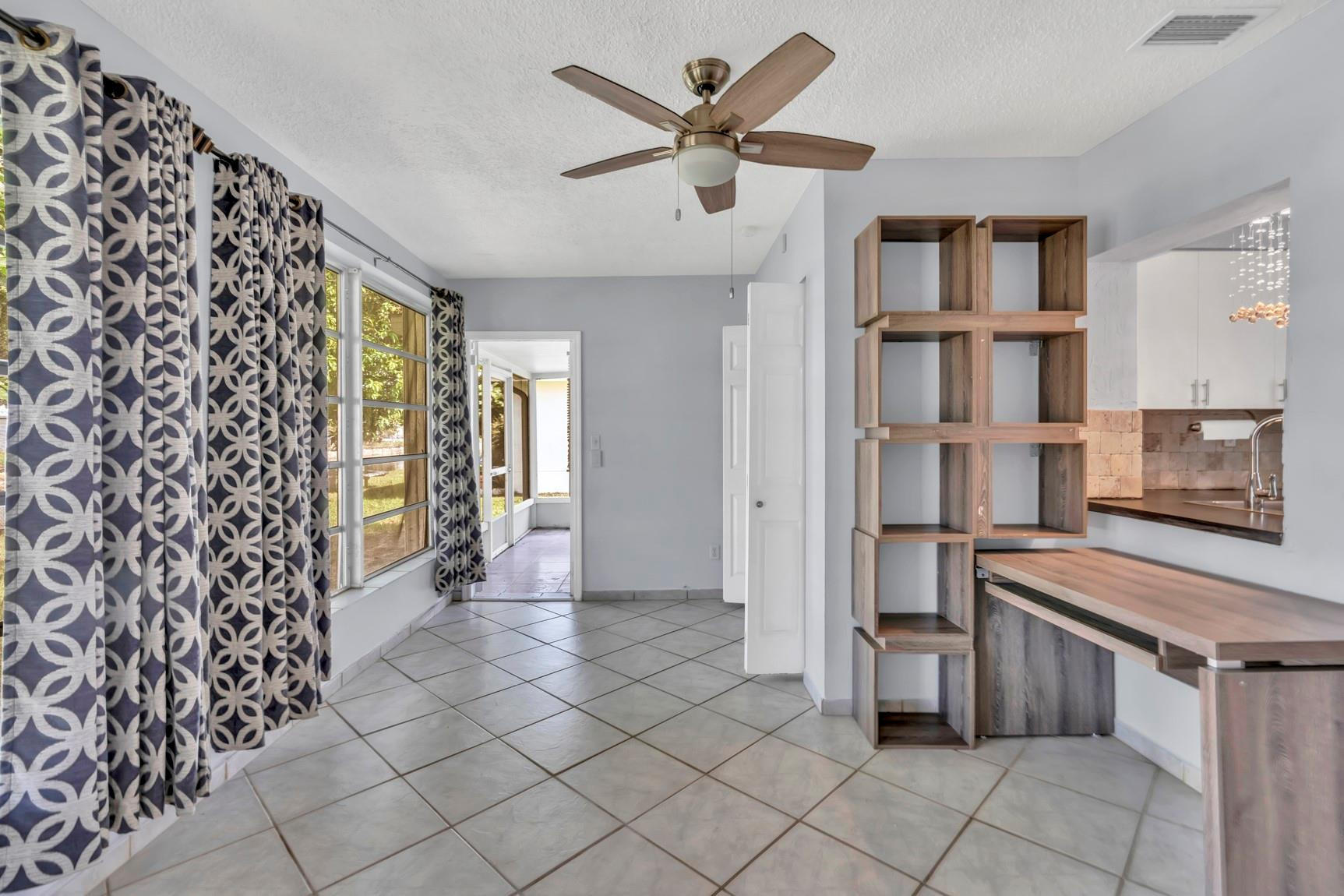 7115 Northwest 73rd Street Tamarac, FL 33321 - Photo 18 of 46 a view of a kitchen with furniture and a refrigerator