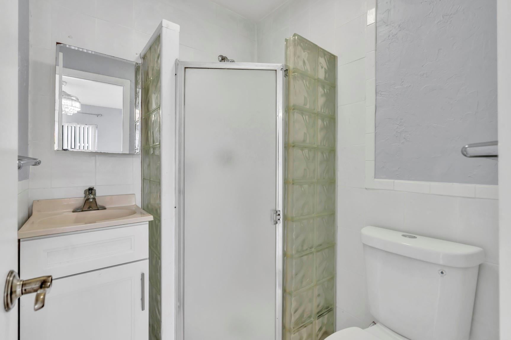 7115 Northwest 73rd Street Tamarac, FL 33321 - Photo 24 of 46 a bathroom with a sink toilet and shower