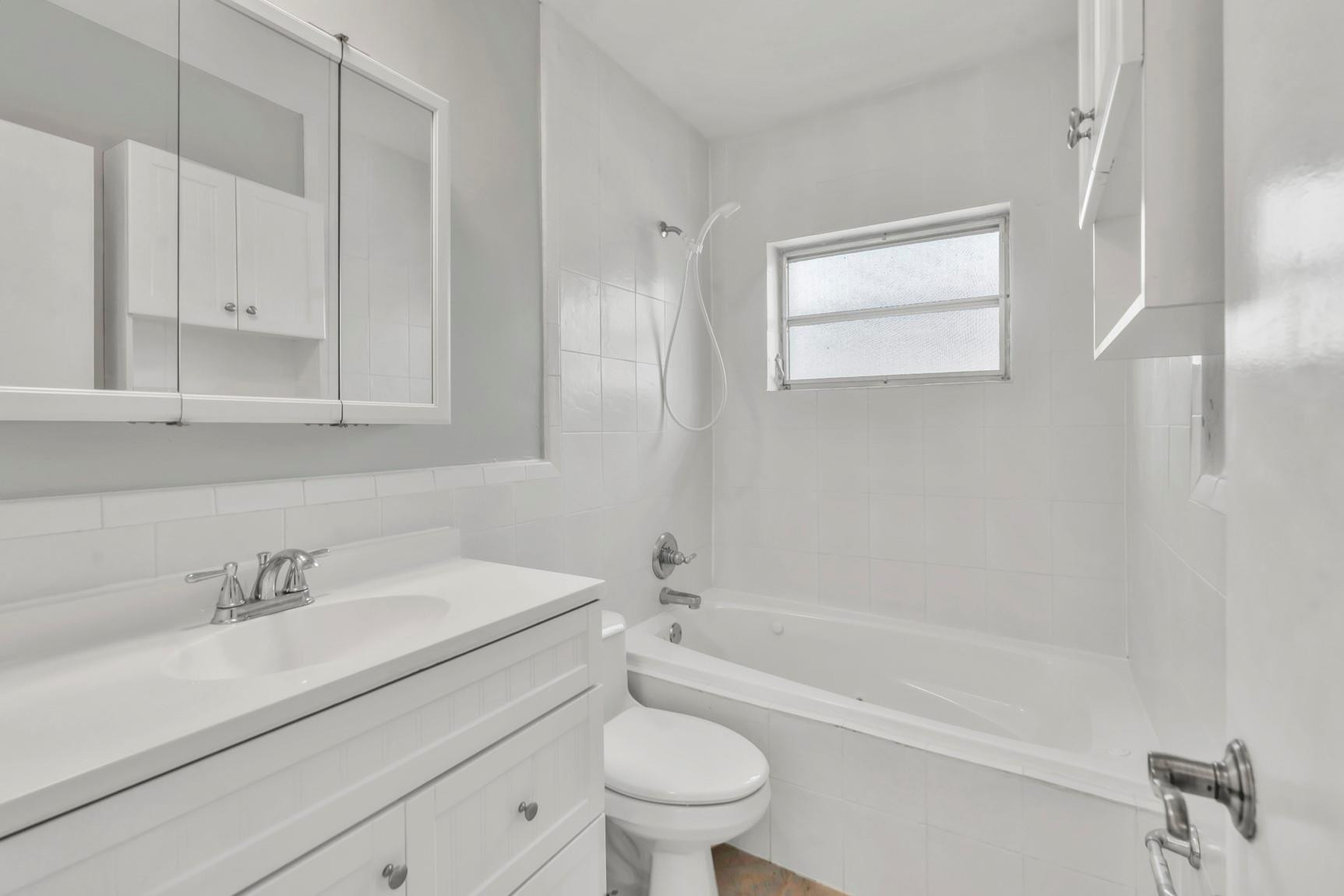 7115 Northwest 73rd Street Tamarac, FL 33321 - Photo 28 of 46 a bathroom with a sink toilet and shower