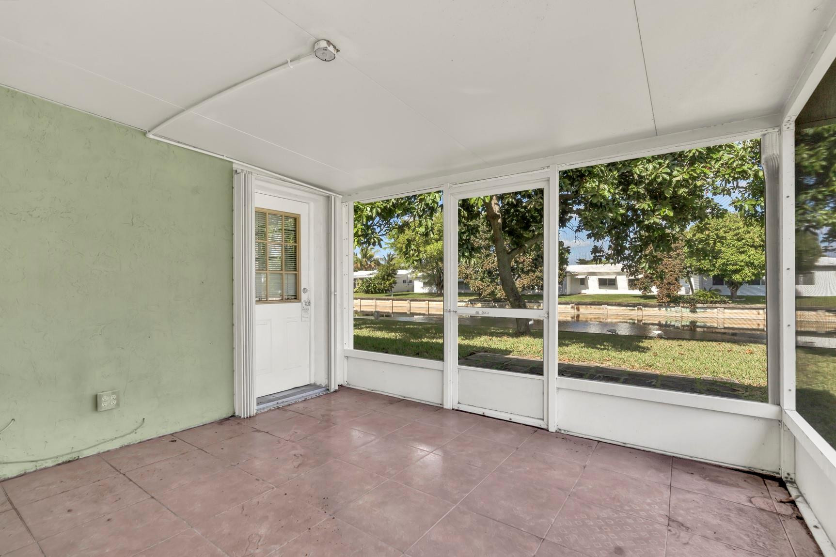 7115 Northwest 73rd Street Tamarac, FL 33321 - Photo 29 of 46 an empty room with wooden floor and windows
