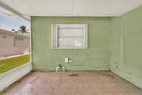 a view of a house with a backyard and a tree