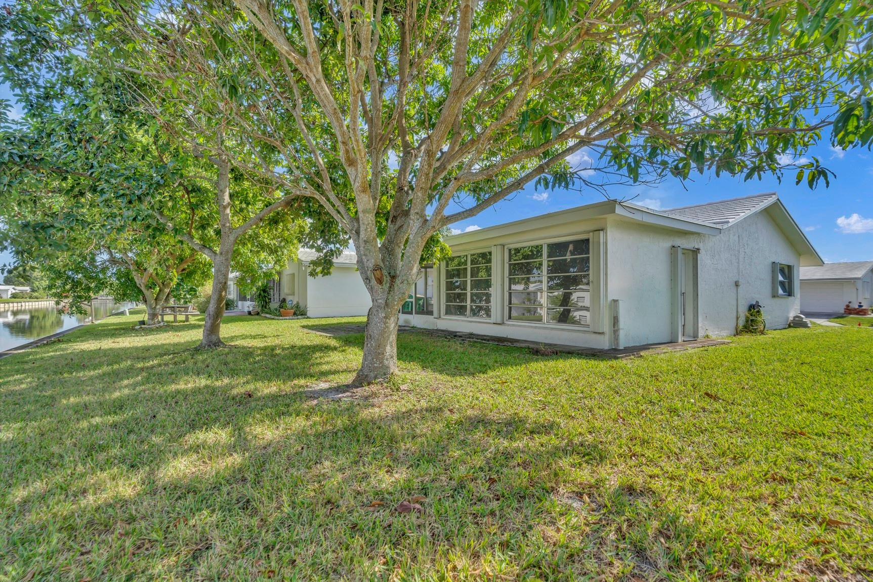 7115 Northwest 73rd Street Tamarac, FL 33321 - Photo 34 of 46 a view of a house with backyard and tree