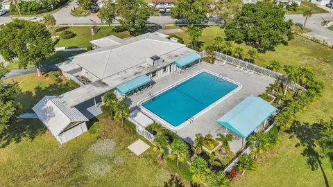 an aerial view of a house with outdoor space and a lake view