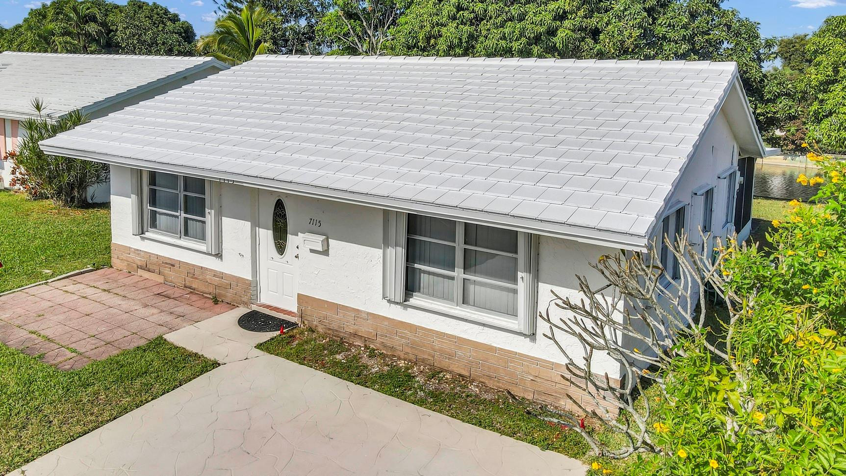 7115 Northwest 73rd Street Tamarac, FL 33321 - Photo 42 of 46 a house with a white door