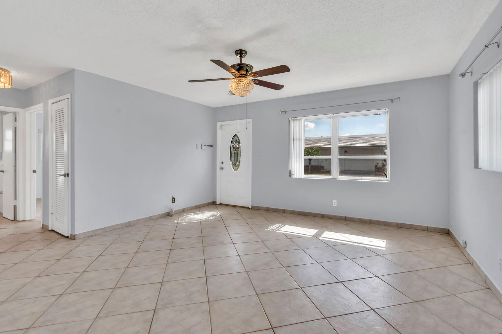 7115 Northwest 73rd Street Tamarac, FL 33321 - Photo 6 of 46 a view of an empty room with a window