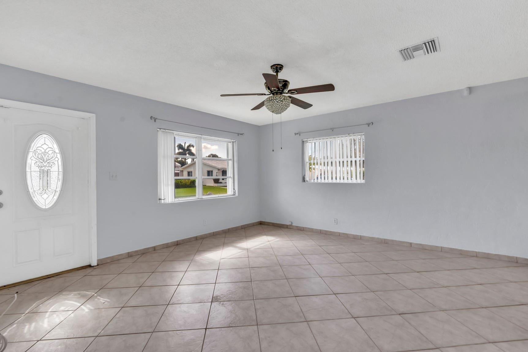 7115 Northwest 73rd Street Tamarac, FL 33321 - Photo 7 of 46 a view of an empty room with a window