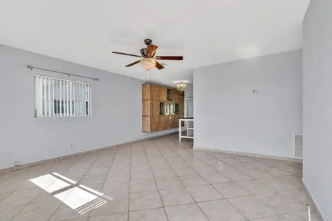 a view of room with a ceiling fan