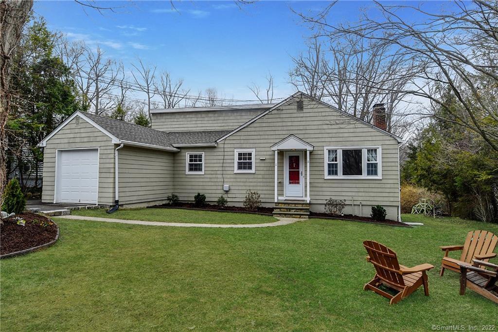 11 Crest Road Ridgefield, CT 06877 - Photo 1 of 1 a backyard of a house with table and chairs