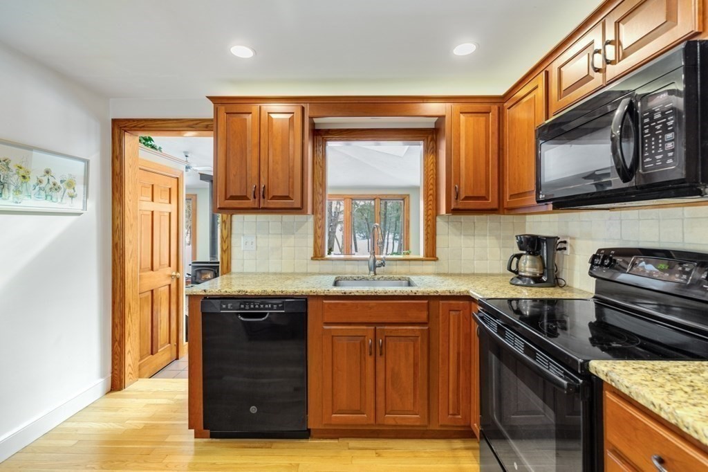 6 Sherman's Bridge Road Wayland, MA 01778 - Photo 14 of 42 a kitchen with stainless steel appliances granite countertop a stove a sink and a microwave