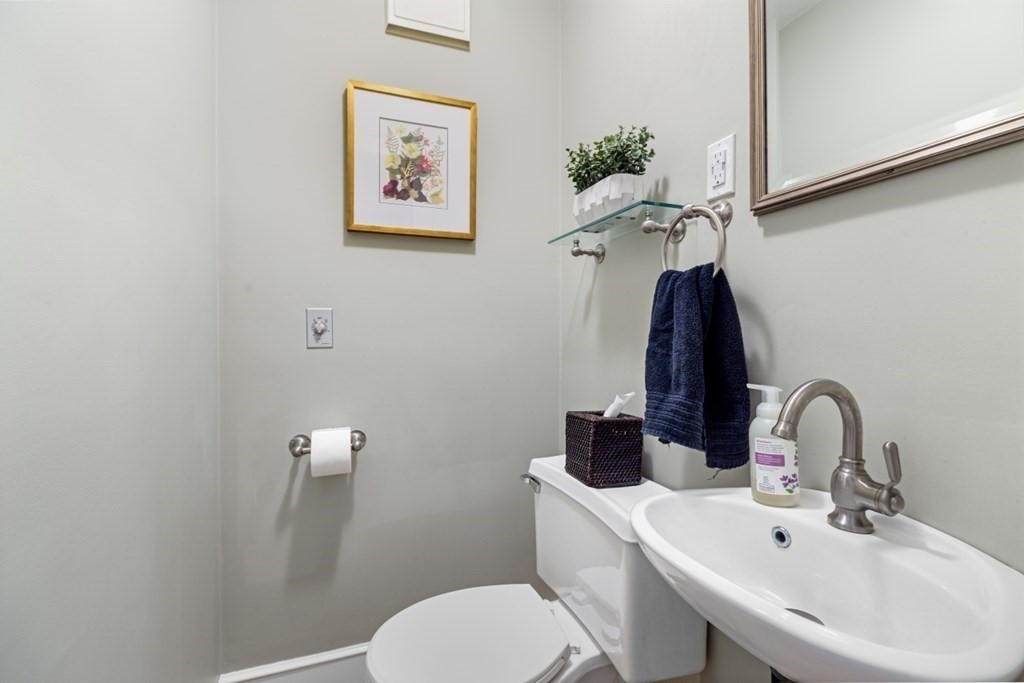 6 Sherman's Bridge Road Wayland, MA 01778 - Photo 18 of 42 a bathroom with a toilet a sink and mirror