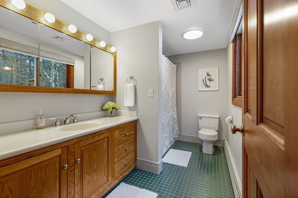 6 Sherman's Bridge Road Wayland, MA 01778 - Photo 23 of 42 a spacious bathroom with a sink and a mirror