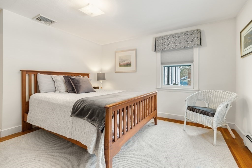 6 Sherman's Bridge Road Wayland, MA 01778 - Photo 25 of 42 a bedroom with a bed a couch and a window