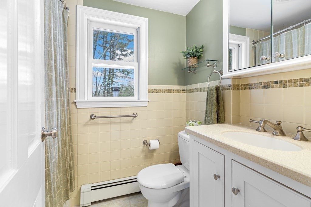 6 Sherman's Bridge Road Wayland, MA 01778 - Photo 26 of 42 a bathroom with a granite countertop sink a mirror and a toilet